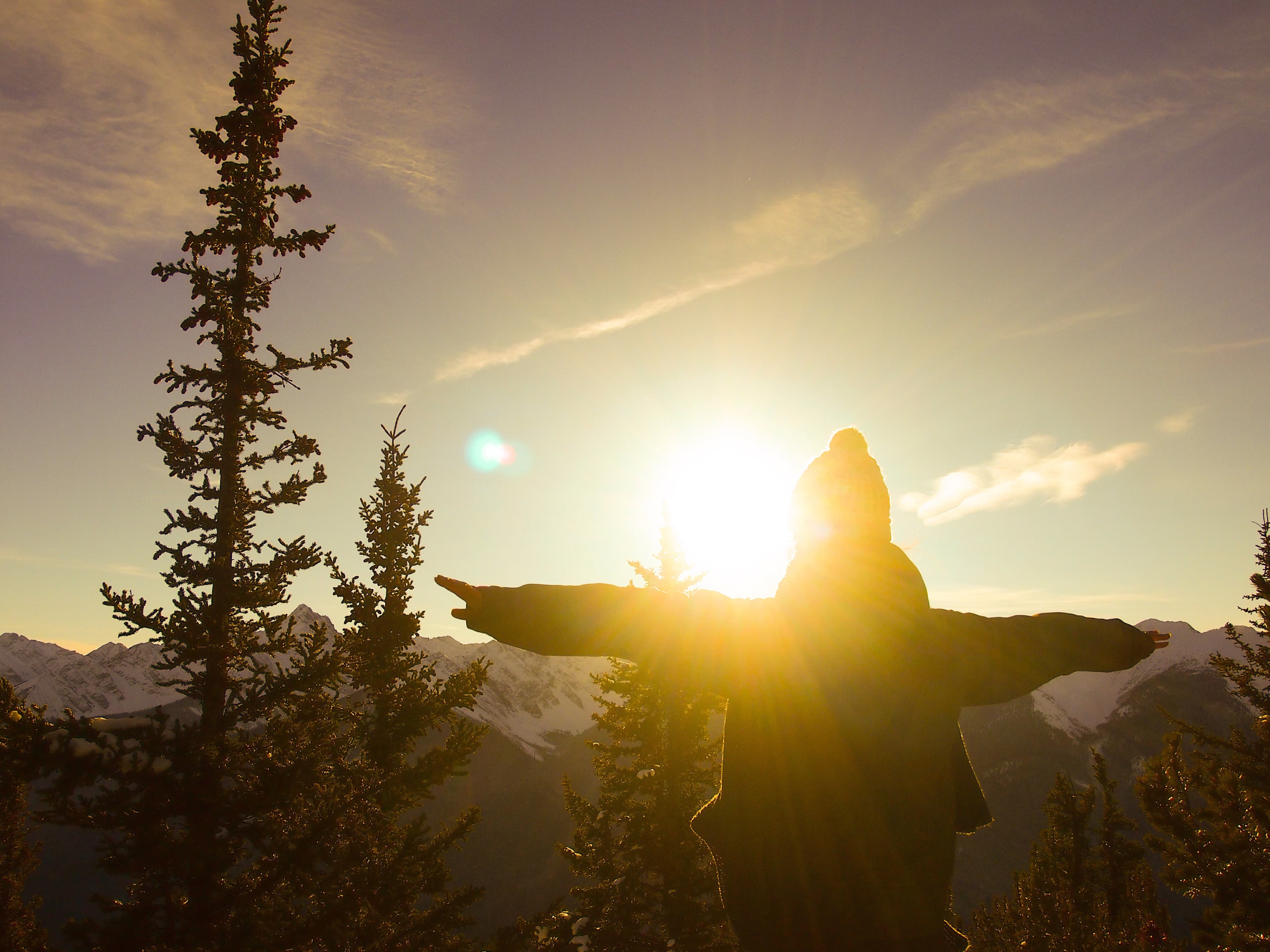 Open arms overlooking a mountain landscape